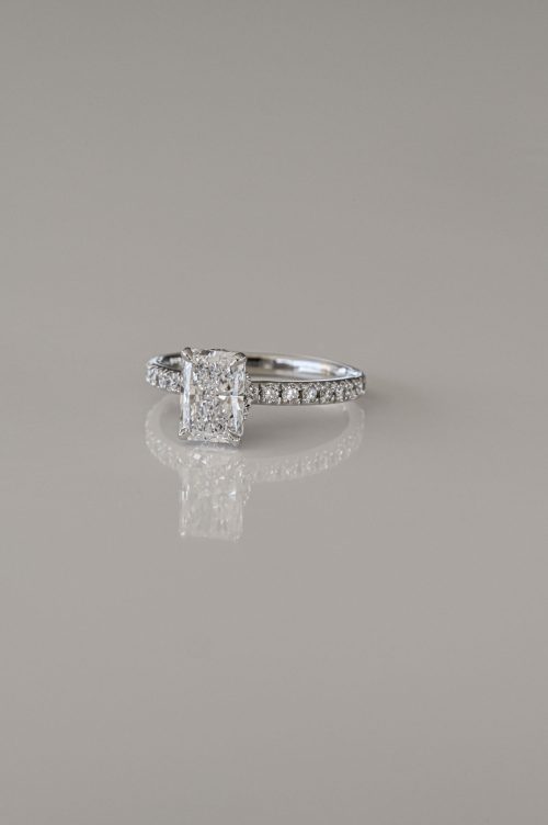 Cecelia engagement ring in 19k white gold, front view featuring an elongated radiant-cut diamond with pavé band and hidden halo accent.