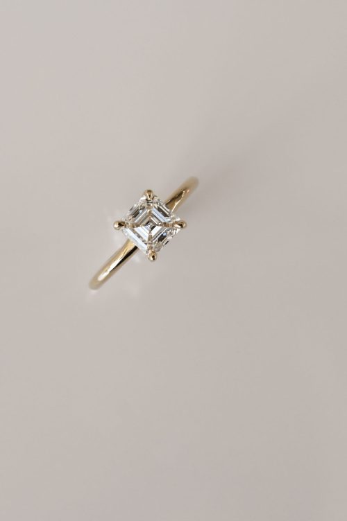 Harper engagement ring in 14k yellow gold, angled top view showcasing an Asscher-cut diamond in a classic four-prong setting.