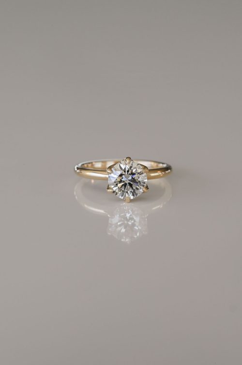 Laleh engagement ring in 14k yellow gold, front view featuring a round brilliant diamond held in a tulip-shaped floral setting.