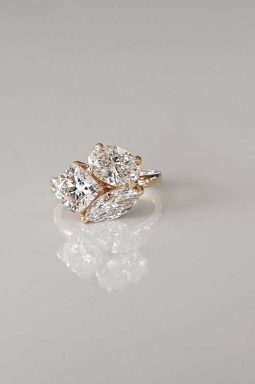 Three-diamond cluster ring in 14k yellow gold, with cushion, oval, and marquise lab-grown diamonds set like spring petals.