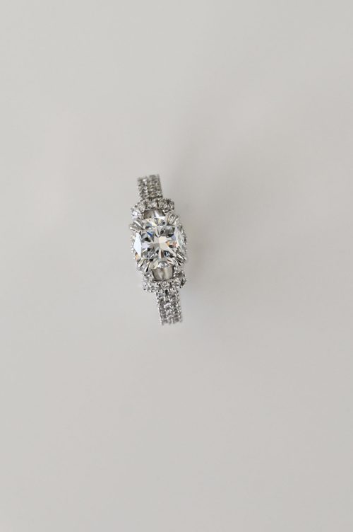 Lorraine engagement ring in 14k ultra white gold, top view showcasing the square cushion-cut diamond with pavé diamond band and halo accents.