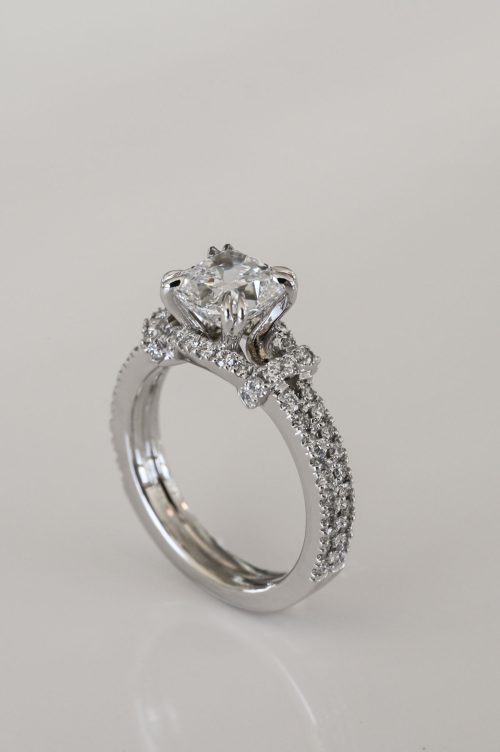 Lorraine engagement ring in 14k ultra white gold, angled view showcasing a square cushion-cut diamond with pavé diamond band and halo detailing.
