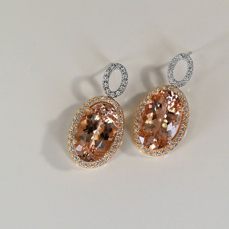 Oval morganite drop earrings in a diamond halo setting with pavé diamond oval studs.