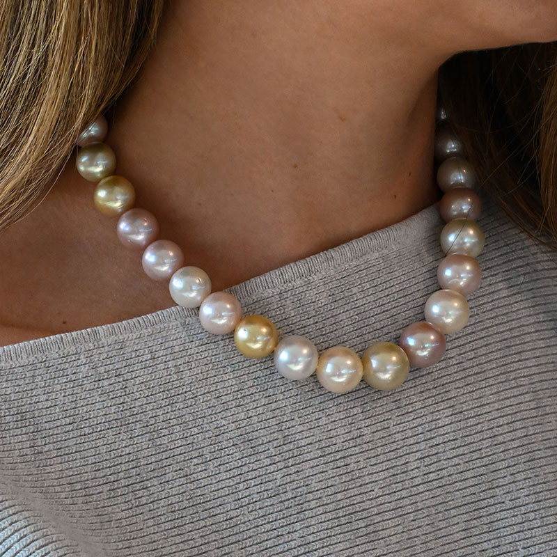 Necklace featuring round pearls in a mix of soft pink, golden, and ivory hues.